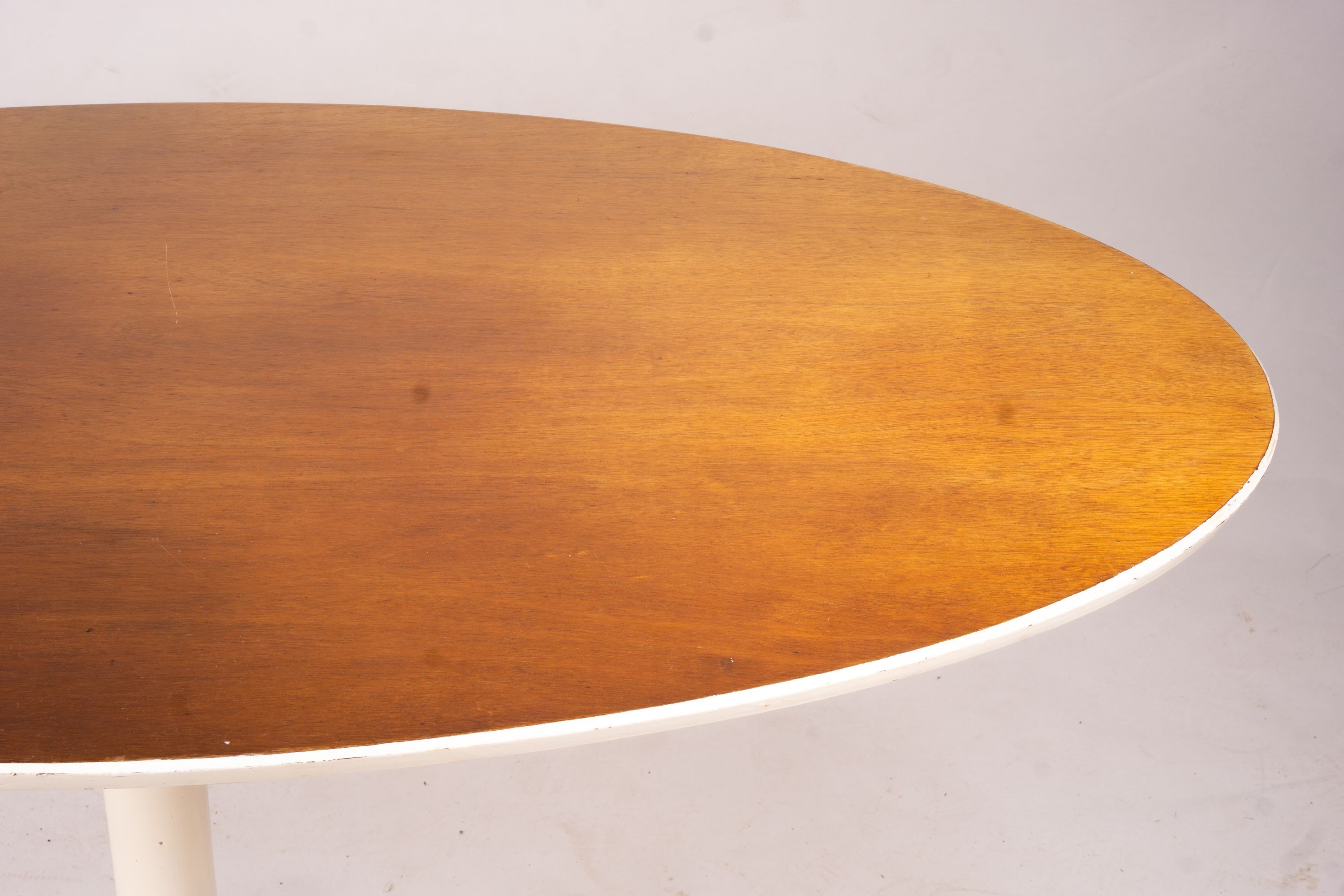 An Arkana style tulip base teak top oval dining table, length 152cm, depth 91cm, height 76cm